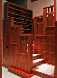 Mahogany dressing room stair draws on Asian tansu chest forms, and the craftsman-style tendency to make interior architecture into “furniture.”